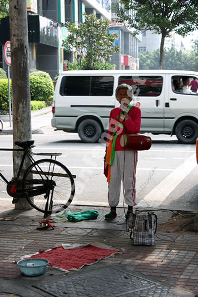 龙口西万佳超市门前卖艺乞讨的老人